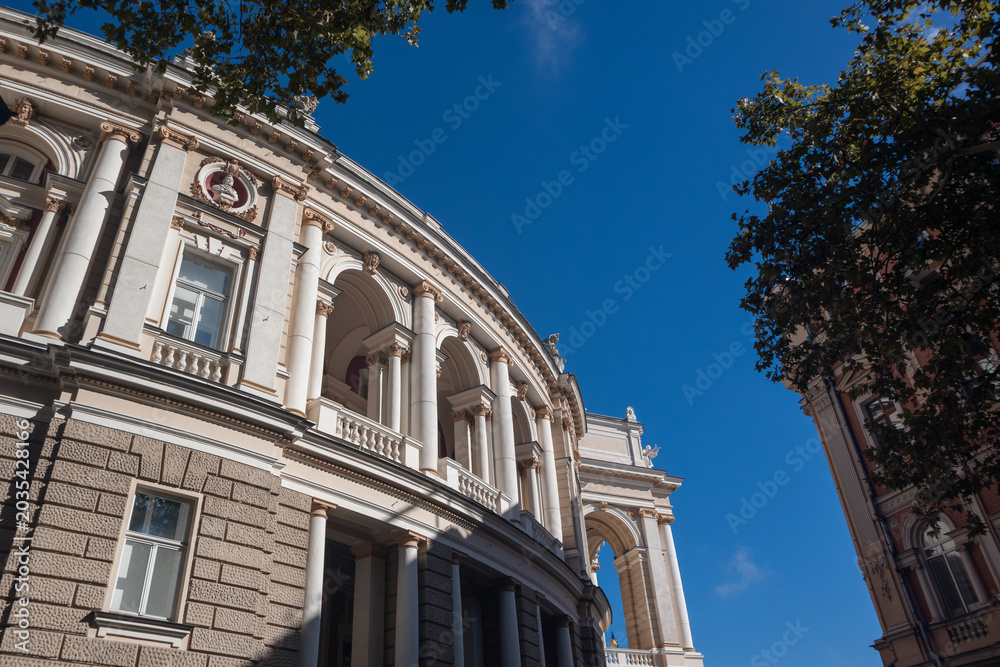 Obraz premium Elegant historic opera house building with arched windows and columns. Look up on Odesa city downtown architecture