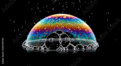 Vibrant soap bubble with rainbow colors on black background