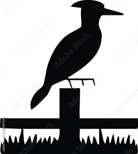 Photos Black silhouette of a bird perched on a crossbeam above a trap.