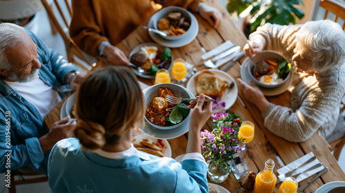 A European nurse viewed from above in soft blue uniform serves a bright breakfast to calm elderly residents at a sunny nursing home table in soft daylight nursing breakfast