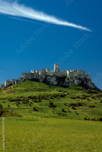 Wide panoramic view of Spis Castle on a green hilltop