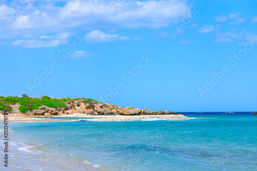 Photography A tranquil coastal scene unfolds with gentle waves lapping a sandy shore against