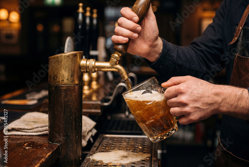 bartender pouring beer into a glass