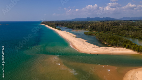 Bild auf Leinwand High altitude drone view of coastal landscape with mountains, sea and fields