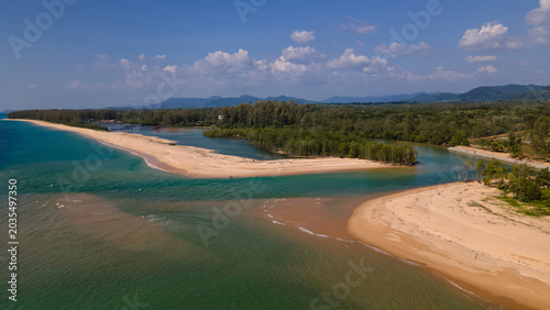 Photos High altitude drone view of coastal landscape with mountains, sea and fields