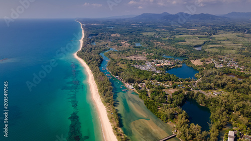 Quadro em tela High altitude drone view of coastal landscape with mountains, sea and fields
