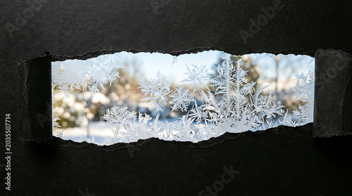 Frosty window view winter scene through icy glass