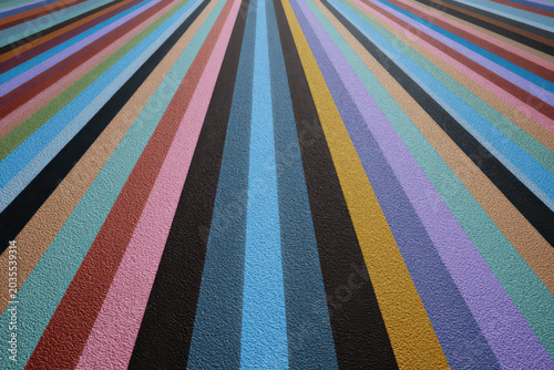 Colorful stripes converging towards the horizon creating a vibrant textured perspective