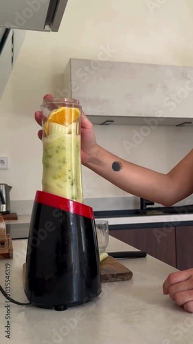 Woman Using Blender in Kitchen Making Fresh Fruit Juice Healthy Smoothie Preparation Home Cooking Lifestyle Close Up Blending Fruits Natural Beverage Nutrition Drink 4K Video