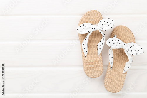Cute sandals on wooden background, top view