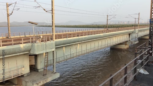 Scenic View of Railway Bridge and Electric Lines Over River