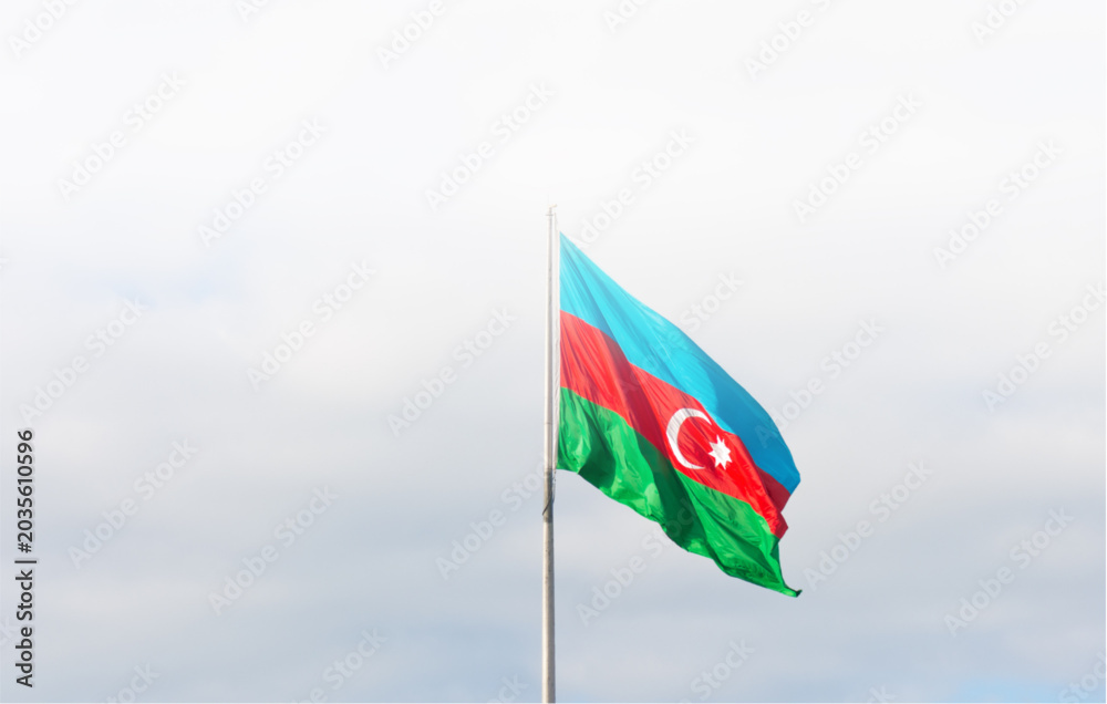 Naklejka premium Azerbaijan flag waving on a pole against a cloudy sky background with vibrant colors