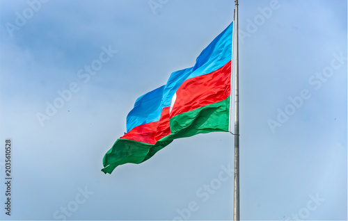 Schilderij op canvas Azerbaijan flag waving on a silver pole against a blue sky with clouds