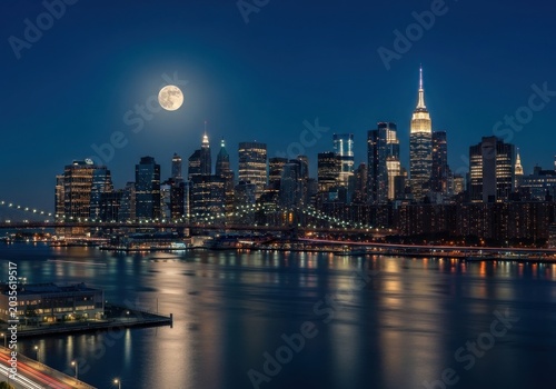 New york city skyline at night with moon reflection on water isolated on white background