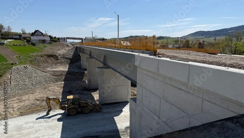 Construction of railway line LK104 with advanced ground stabilization and engineering structures. Geotechnical works including pile walls, soil reinforcement, ground nails, and slope protection system