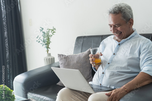 Senior man connecting with family on laptop video call