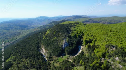 Aerial view of Ucka Nature Park in spring, showcasing lush forests and rolling hills under a clear blue sky. A pristine natural escape in Croatia.