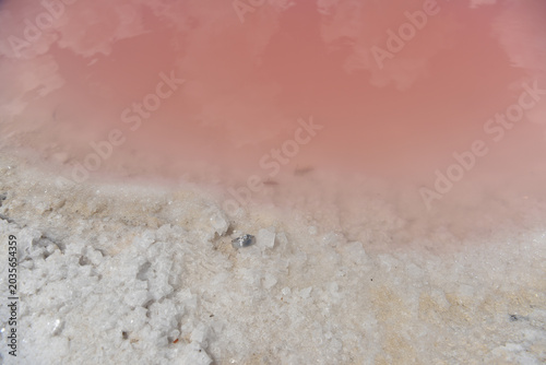 Wedding ring resting on white salt crystals