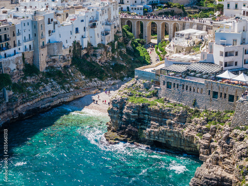 Aerial drone panorama view of Polignano a Mare with Lama Monachile beach, stunning Adriatic sea coastal townscape in Puglia, southern Italy