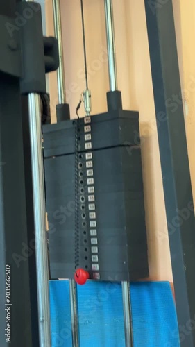 Moving weight stack on gym cable machine with full vertical motion and selector pin on lower plate