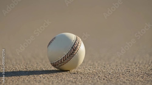 White cricket ball bouncing on ground in slow motion
