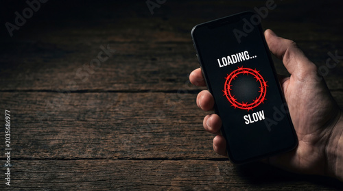Man hand holding smartphone with circle of barbed wire graphic on screen. Internet blocking, social media censorship and restricted access. Digital connectivity failure and network error.