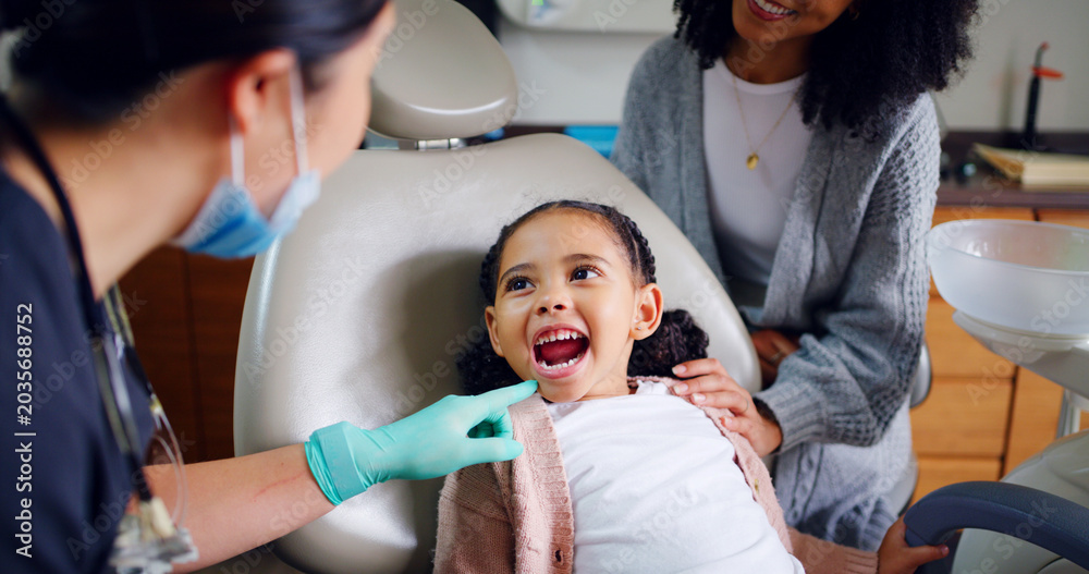 Fototapeta premium Child, mouth and consultation with dentist in office for dental checkup, show cavity and extraction. Mother, kid and paediatric hygienist for oral health, teeth whitening and inspection for cleaning