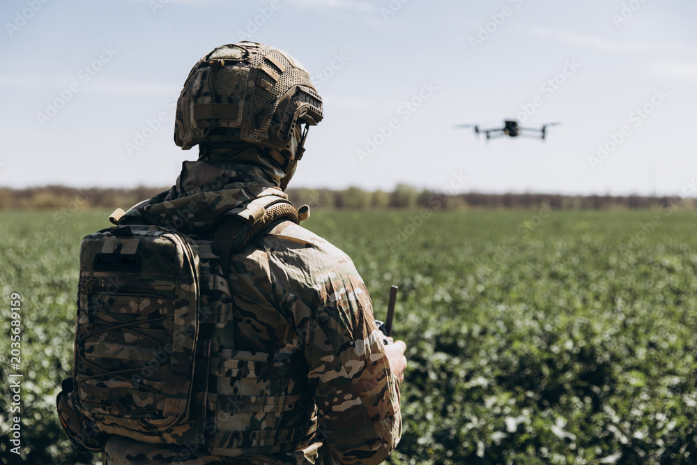 Fototapeta premium Ukrainian military pilot operating surveillance drone in field