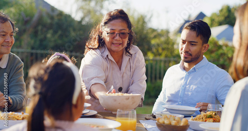 Obraz na plátne Serving, generations or Asian family at table with meal, bonding together or reunion in healthy relationship