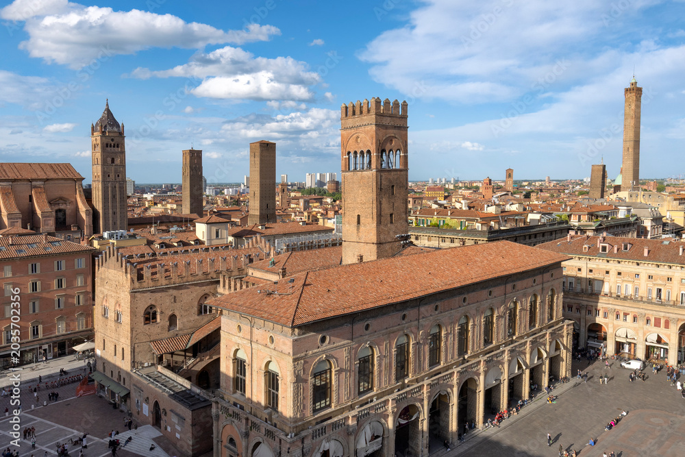 Fototapeta premium Aerial view of Piazza Maggiore in Bologna old town, Emilia Romagna, Italy, with historic architecture, Palazzo del Podesta and towers at sunrise. Italian cityscape. Travel destination in Europe