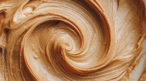 Minimalist still life featuring rich peanut butter texture on white