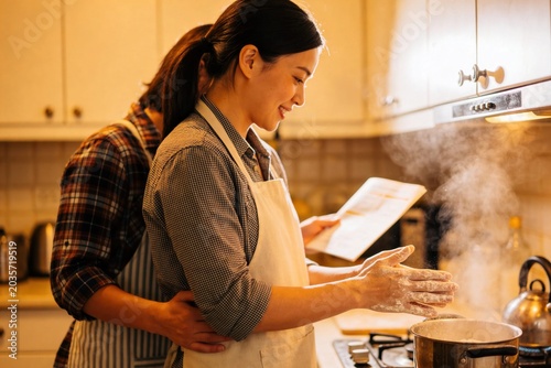 The Recipe Reader, Domestic HarmonyThe Recipe Reader, Domestic Harmony, Cooking Together in a Cozy Home Kitchen with Flour and Steam