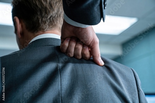 The Shoulder Squeeze, Transferred Strength, Tension in Office: Close-up of Businessman with Hand on Shoulder