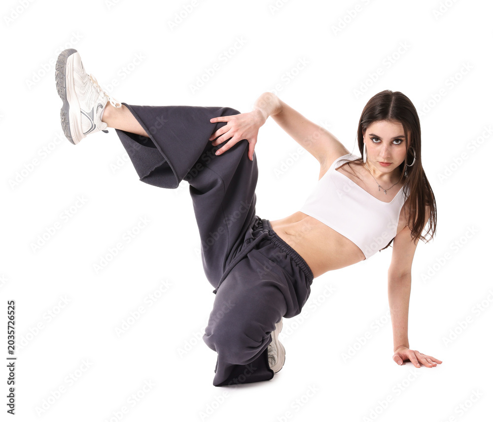 Naklejka premium Young woman performing hip-hop dance on white background