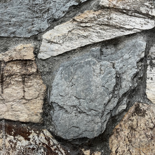 Natural stone wall texture with layered rock surface and gray tones