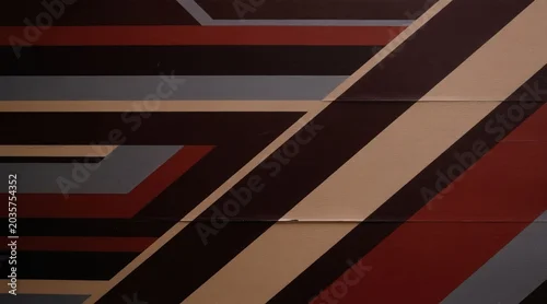 Panel kuchenny z motywem Abstract pattern of diagonal stripes and geometric shapes. Dark red, brown, beige, and gray colors interlace on a textured background. Graphic design suitable for urban or modern themes.