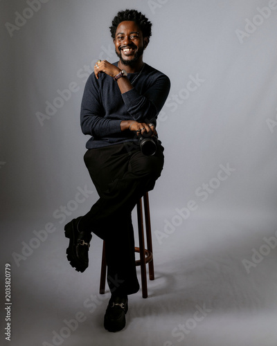Bild auf Leinwand Beautiful and elegant black man, photographer posing for photos in a photography