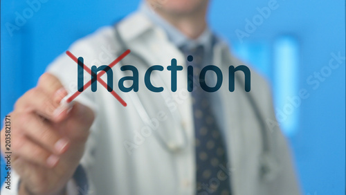 Photos Doctor crosses out the word inaction in red, symbolizing proactive healthcare, d