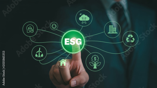 Environmental social and governance esg concept with businessman pointing at green sustainable icons.