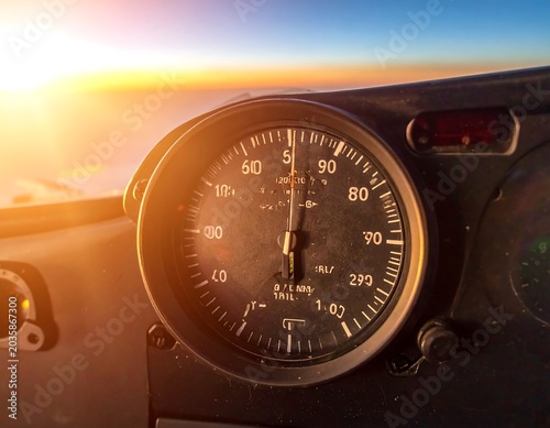 Sunlit Aircraft Altimeter Displayed in Cockpit During Sunset Flight