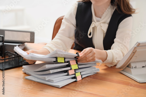 Businesswoman with stack of...