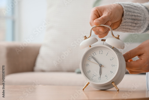 Female hands changing alarm...