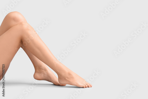 Legs of woman on light background