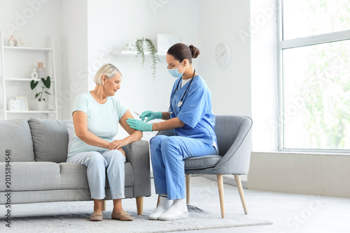 Senior woman receiving vacc...