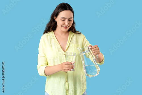 Young woman pouring water i...