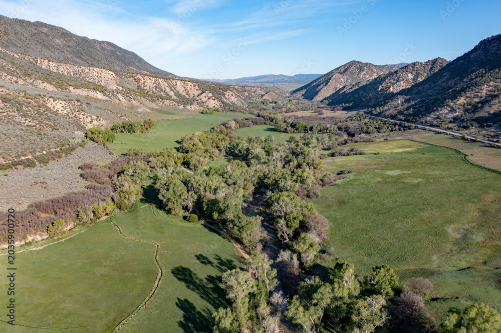 Obraz premium Aerial view of Grass Valley in Garfield County, Colorado on early spring morning under sunny diffuse cloudscape.