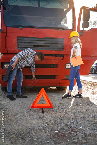 Female truck driver having problem with the truck, malfunction by the road 