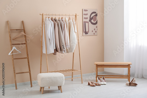 Rack with stylish clothes, ...