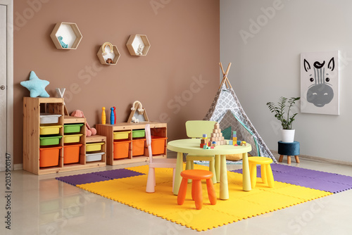 Foto Interior of children's room with table, play tent and toys