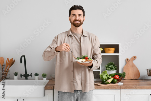 Handsome man eating boiled ...